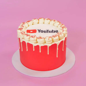 Corporate Drip Cake with Logo featuring a red drip design and edible YouTube logo plaque on top by Crumbs & Doilies